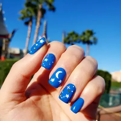 Blue nails with moon and star details