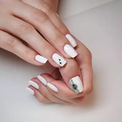 White nails with black sparkles and baby Yoda design