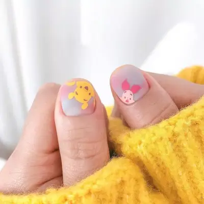 Blue and pink nails with Winnie the Pooh and Piglet designs