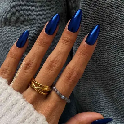 Manicure featuring long chrome cobalt blue nails 