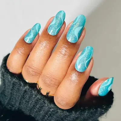 Aquamarine sheer nails with glitter and opaque turquoise swirls