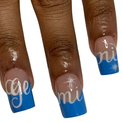 Square blue French manicure nails with white cursive Gemini detailing