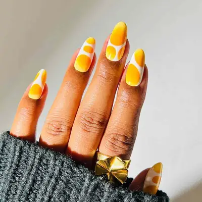 Abstract Leo nails with white and ombre yellow blobs on long oval nails
