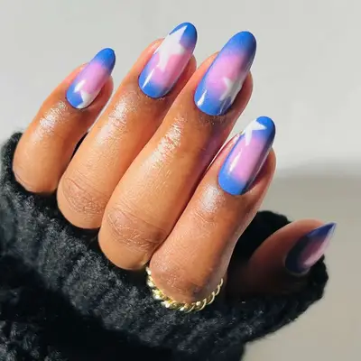 Blue and pink aura nails with white star accents