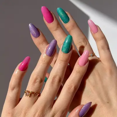 Skittle nails in hot pink, purple, light pink and teal