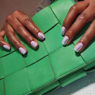 Lavender manicure with silver half-moon design on side of nail