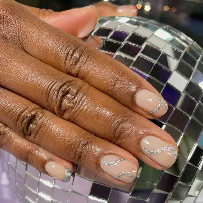 Neutral manicure with silver squiggle metallic nail designs