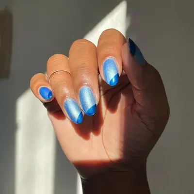 Light blue metallic nails with dark blue metallic diagonal tips