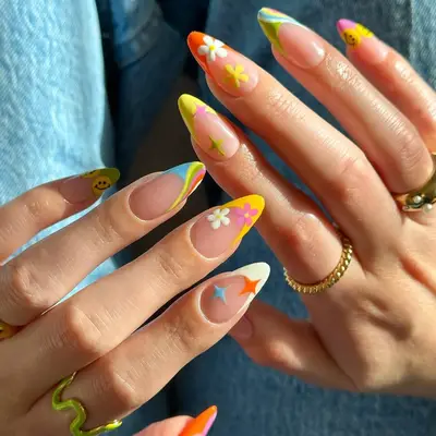 Hands with long floral and swirl nail designs