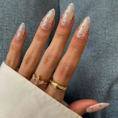 Shimmery almond nails with pink rhinestones