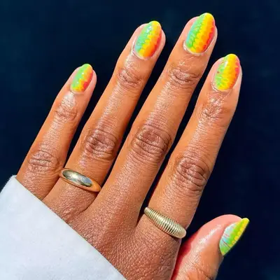 Red, orange, yellow, and green tie dye nails