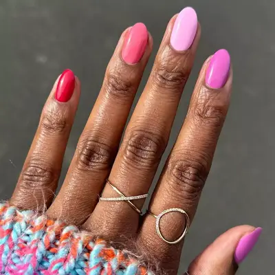 Pink Skittle manicure with red, mauve, baby pink, and bubblegum pink polish