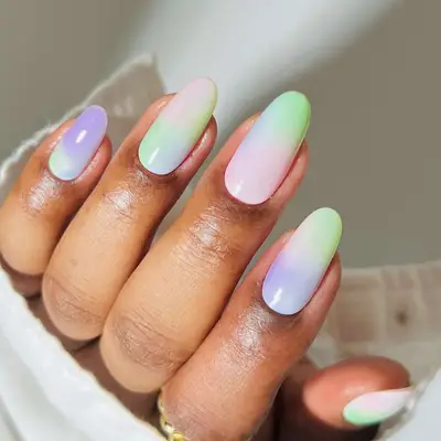 A pastel manicure in a cloudy ombrÃ© gradient design