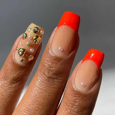 Red square French mani with pearl and gold seashell accents