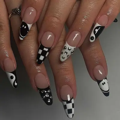 a black and white mismatched design manicure