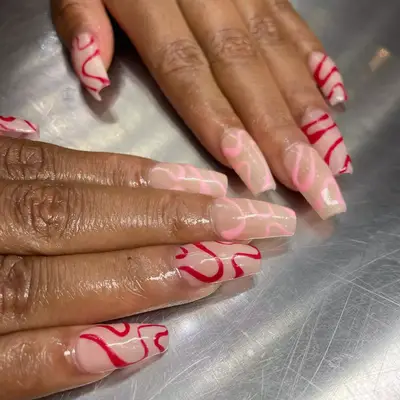 manicure with pink and red swirls on neutral base