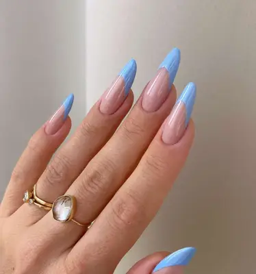 close up of hand showing off fresh manicure, frosted blue french tips