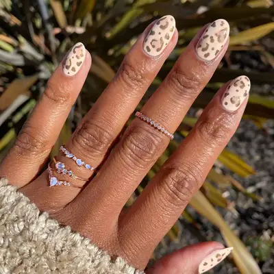 Nude and black tiger print nails