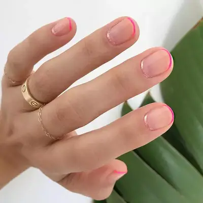 Subtle hot pink French manicure with pale shimmery pink at cuticle