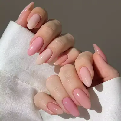 Almond shaped nails with pink confetti gradient tip