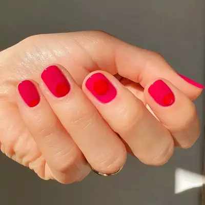 Magenta nails with orange sunrise design on each nail