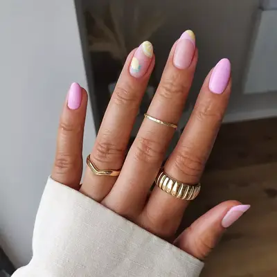 Baby pink nails with lemonade designs on ring and middle finger