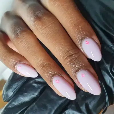 A pink manicure with lines on it that resemble a rose quartz crystal design