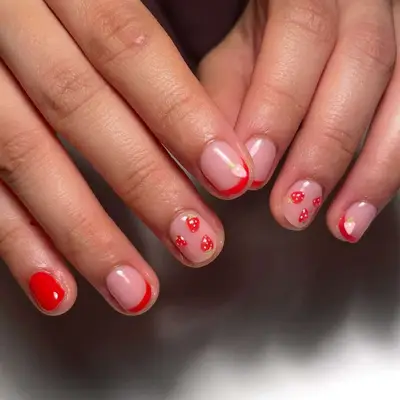 Manicure featuring minimalist red and floral nail art on a natural base