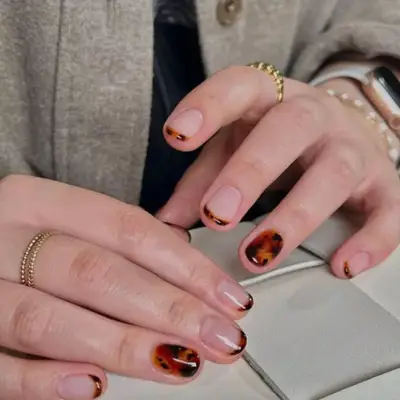 Tortoiseshell baby French manicure with full tortoiseshell accent nail