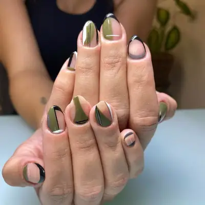 Manicure with black baby French tips and olive and white abstract geometric design
