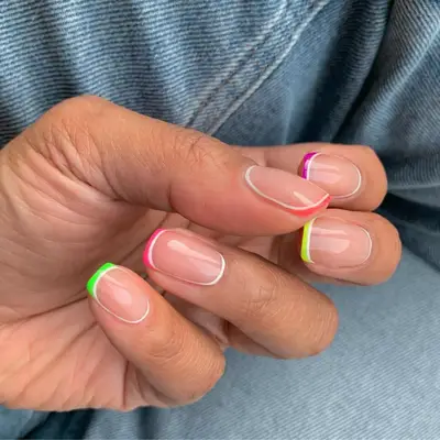 Close up of assorted neon colored baby French tips.