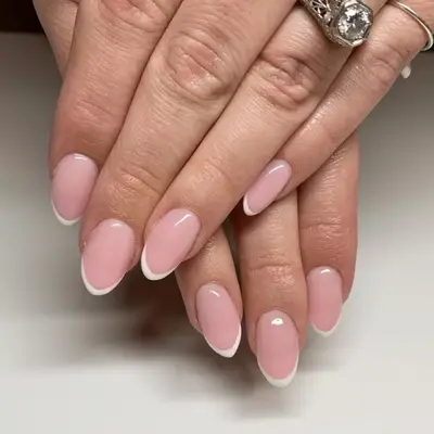 Baby French manicure with brown tips and small dots near cuticles