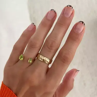 Brown and white cow print baby French tip manicure