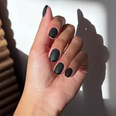 Black baby French manicure with matte base and glossy tips