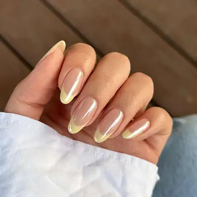 Butter yellow French manicure topped with chrome