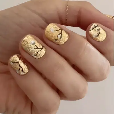 manicure with gold foil base and florals