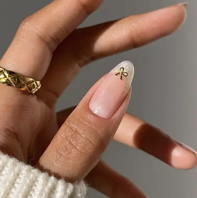 sparkling French manicure with a bow