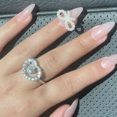 sparkly pink nails with pearl bows