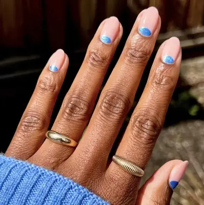 Blue half-moons on pale pink nails