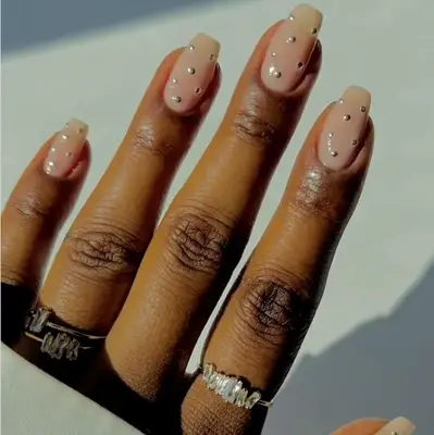 nude nails with silver polka dots