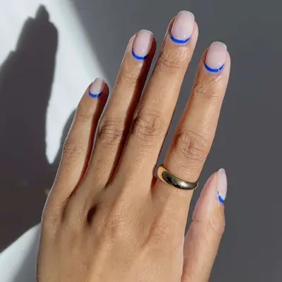 reverse French mani with bright blue 
