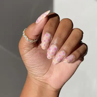 Hot pink and orange pops of color on pale pink nails