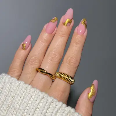 pink manicure with gold chrome accent