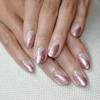 Glitter manicure with silver French tips and rose gold cuticle half-moons