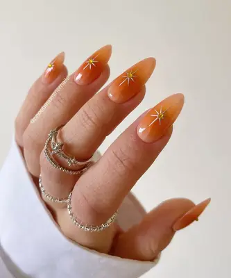 Peach nails with chrome star design