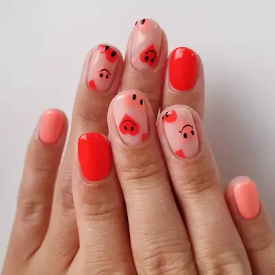 peach nails with smile and heart designs
