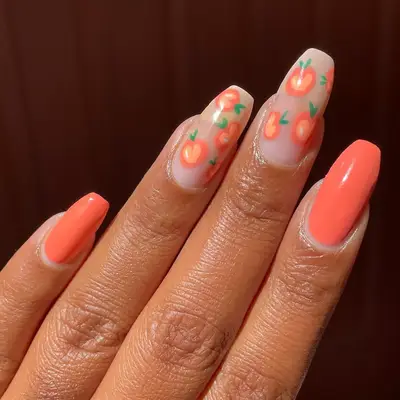 a thumb with shimmery peach nail polish