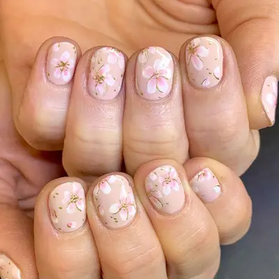 nude nails with pink and white lily designs