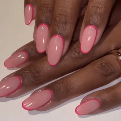 Manicure with light pink base with hot pink outline