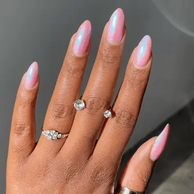 Manicure with candy cotton pink polish with a blue shimmer top coat